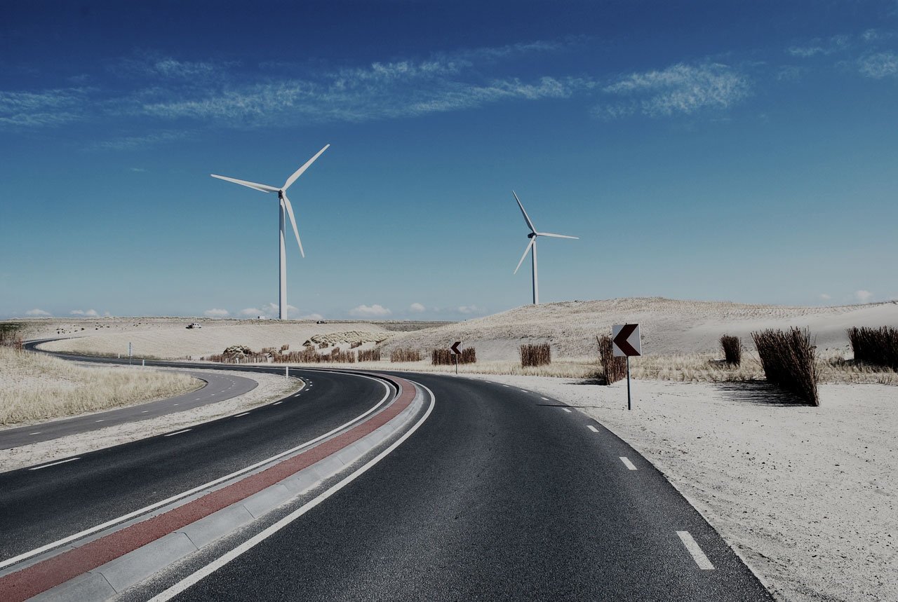 Open highway with windmills in the distance