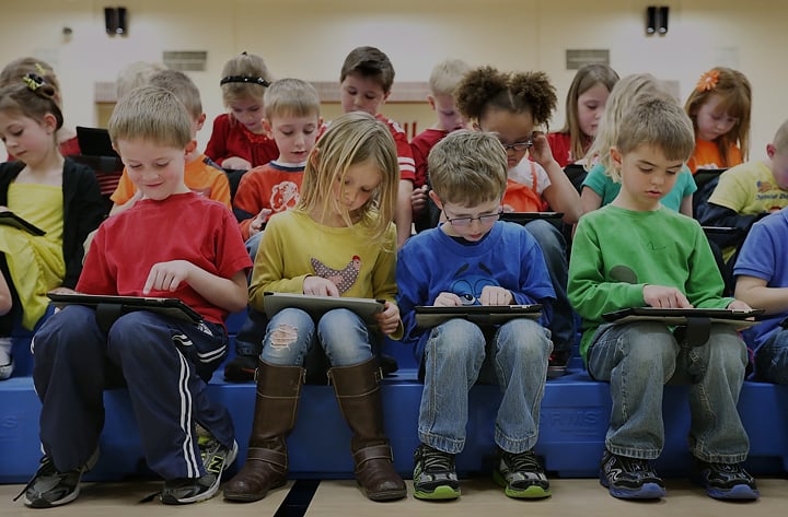 Students in the classroom learning on tablets