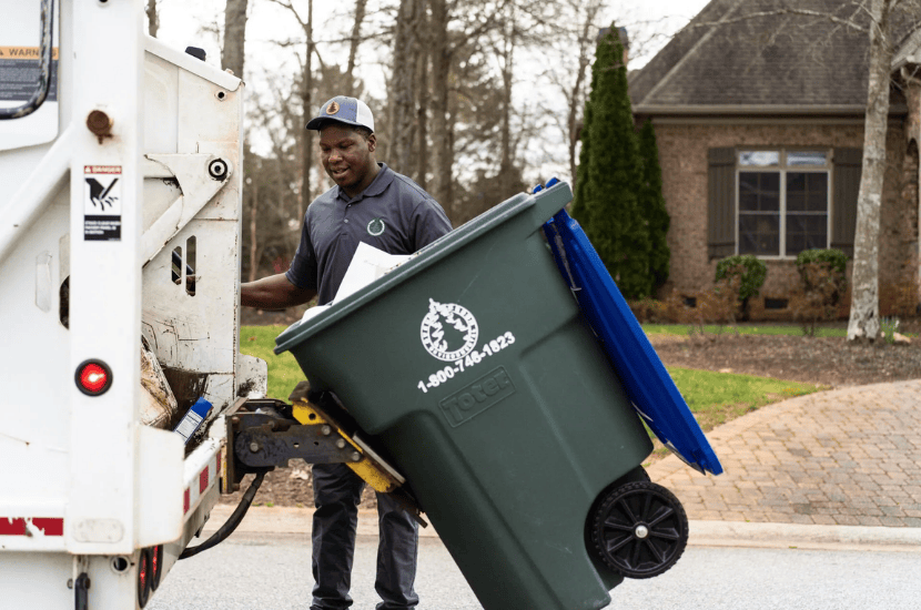 Man Emptying Recycling Bin into Truck